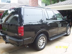 The paint reflects the cement, and the wooden fence. Call or email us today to bring back your paints' shine and reflection!